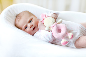 Cute baby girl playing with plush animal toy