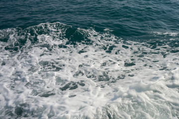 Naklejka na ściany i meble blue sea stormy waves with white foam