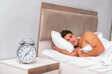 Man having trouble waking up in the morning