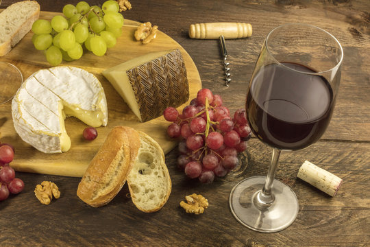 Wine and cheese tasting with bread, grapes and glass