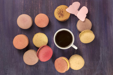 Black coffee and macarons with paper butterfly