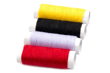 Colorful spools of thread isolated on white background