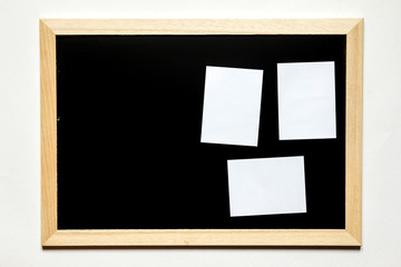 Note paper in black board with wood frame on white background