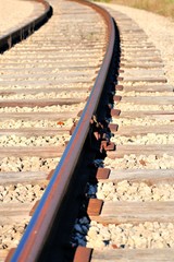 Fototapeta premium Traditional tie plates and spikes seure modern welded rail to traditional wooden ties. Time honored method of constructing railroads for well over a century in the United States.