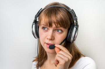 Call centre operator with headset at workplace in call center