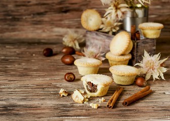 small round Christmas cakes with nuts and cinnamon, space for text