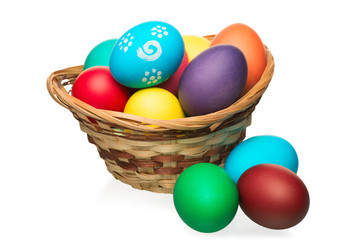 Fototapeta na wymiar symbol of the spring holiday of Easter - colored eggs in basket