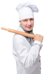 Vertical portrait of a cook with a rolling pin for dough isolate
