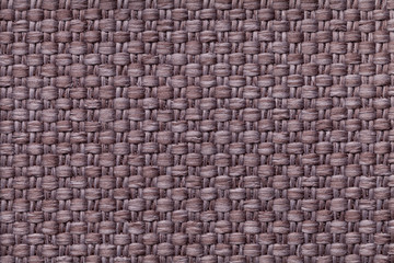 Brown background with checkered pattern, closeup. Structure of the fabric macro.