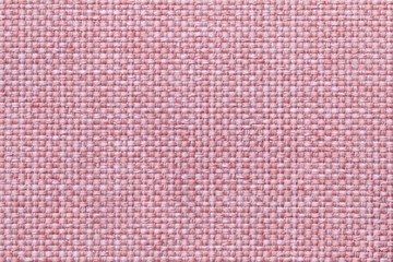 Pink background with checkered pattern, closeup. Structure of the fabric macro.