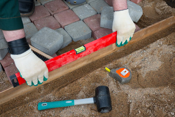 Mason worker making sidewalk pavement