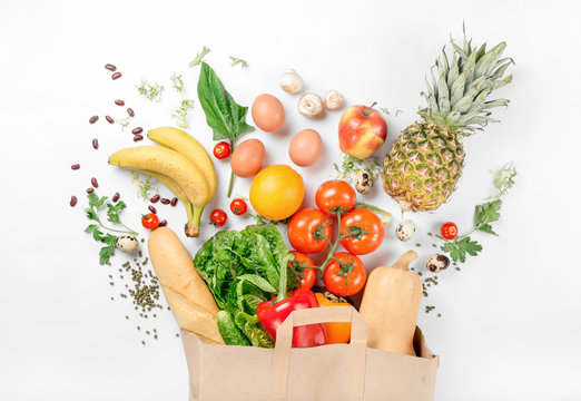 Paper bag of different health food on a white background