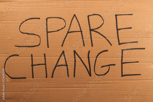 "The words "Spare Change" writte on a cardboard sign" Stock photo and