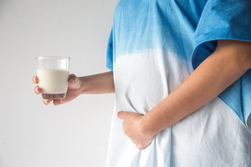 Fototapeta na wymiar Pregnant woman holding glass of milk