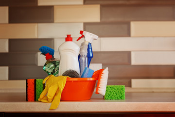 Cleaning set with products and supplies on kitchen table