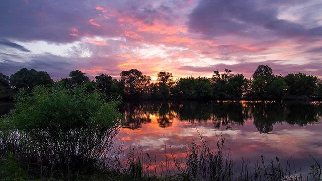 Colorful landscape time lapse of beautiful sunrise over Desna river in Ukraine.