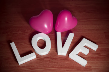 Valentine day present - love with pink heart balloons red background