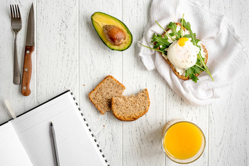 sandwich with poached eggs on wooden background top view mockup