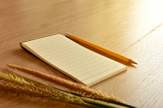 Notebook with a pencil, flowers on the table,