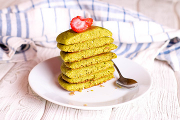 green pancakes on a white plate for breakfast, horizontal