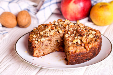 homemade apple pie with nuts on a plate, horizontal