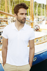 Fototapeta premium Man standing at dock, looking away