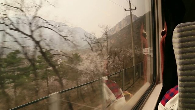 looking at the great wall from a train windou in early spring