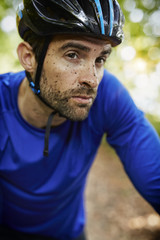 Fototapeta premium Muddy cycle man looking away, close up