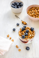 Fitness breakfast with granola and berries on white background