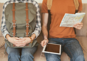 Young couple going on a journey. Man checking the route with map and digital tablet. Active lifestyle and travel vacation concept
