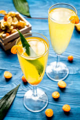 cocktail with physalis in glass on wooden background