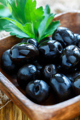 Black olives and parsley close-up.