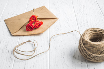 envelope and flowers on wooden background mock up