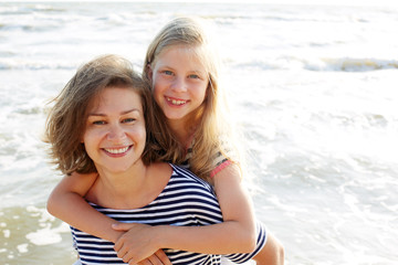 Happy family resting at beach in summer