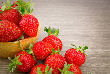 Strawberry in bowl on wooden