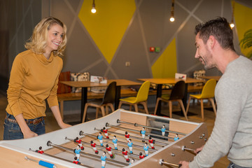 workers playing table football