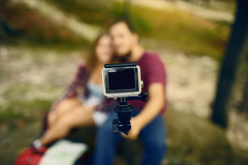 Couple making photo. Focus on camera