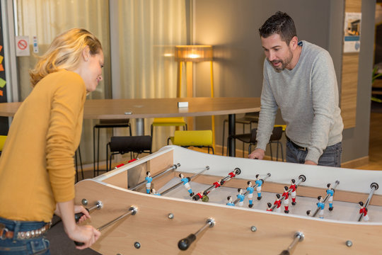 workers playing table football
