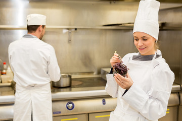 Young female chef cooking