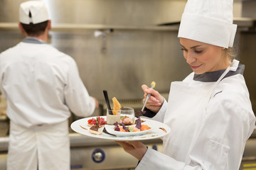 Young female chef cooking