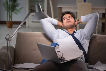 Businessman workaholic working late at home