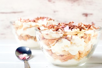 Cheesecake dessert in glass jar on wooden background. Healthy dessert. Healthy food concept.