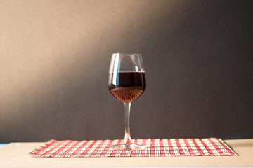 Pouring red wine into the glass.