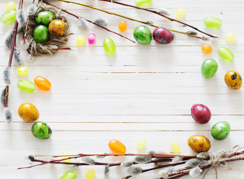 Easter eggs and willow branches on a white background