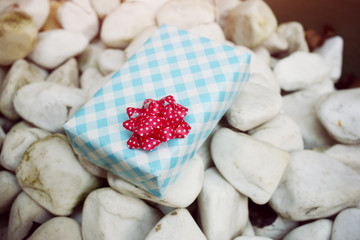 Wrapped gift on a white rocks