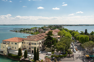 View of colorful old buildings in Sirmione and Lake Garda from Scaliger castle wall, Italy