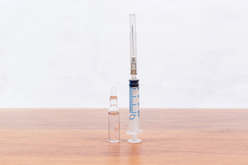 Medical mask and a mercury thermometer - close-up on the table. Means of protection from the cold and flu season.