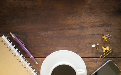 Hot cup of coffee on wooden work table