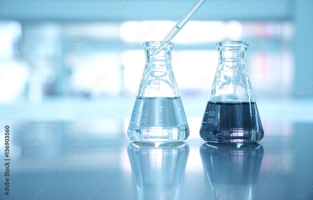 Wall mural two flask with pipet drop in water at science laboratory