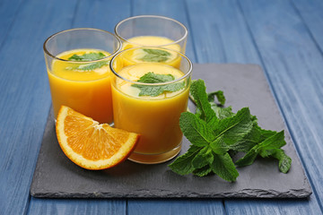 Fresh orange juice with fruits on table